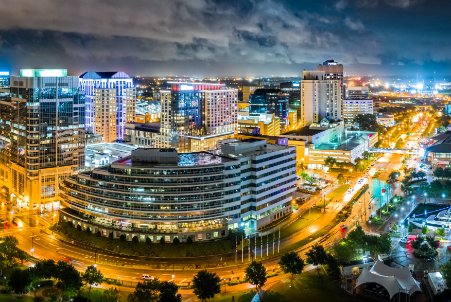 Man front center of a room with people