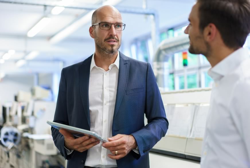 Two men discussing project funding