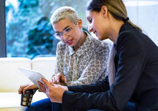 Two women review newly released SBIR topics.