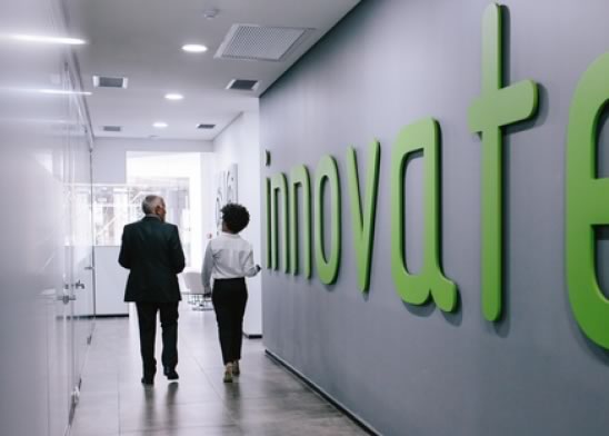 Business people walking through office corridor