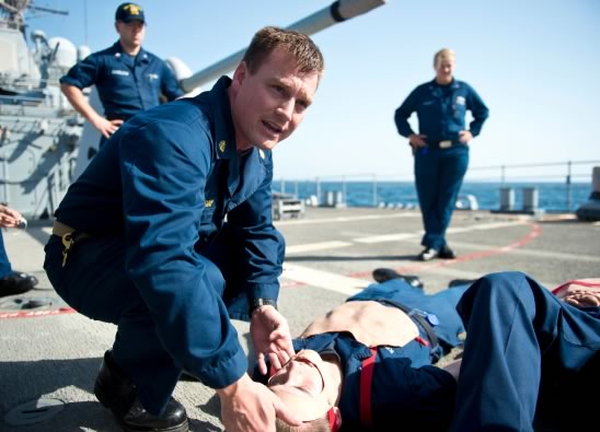 Servicemember training CPR on a mannequin