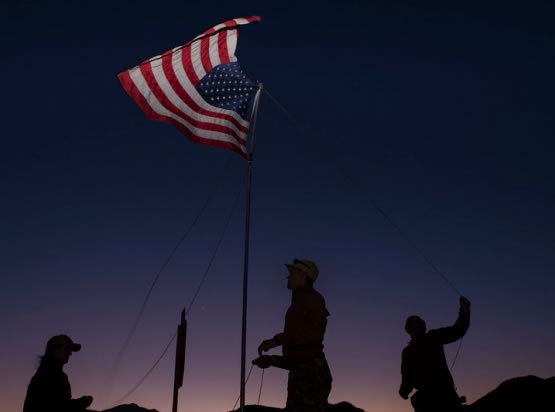 Decorative image of evening sunset with the U.S. flag flowing in the wind