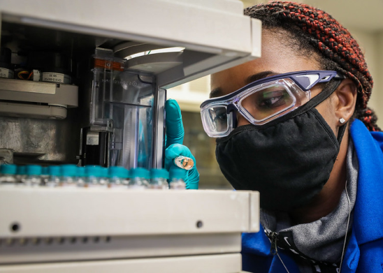 NavalX Partners | decorative image of a lady working with a laboratory microscope