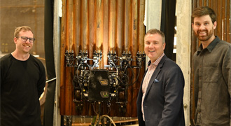 Navy leader discusses tech with business person.