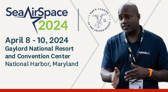 Navy leader discusses tech with business person.